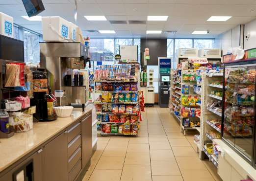 a convenience store with a coffee station, snacks and a checkout counter