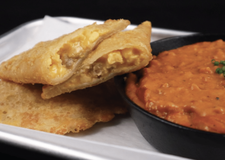 Two Sausage, Egg, Cheese & Potato Empanada Plate And Next To A Dish Of Mexican Chorizo And Gravy