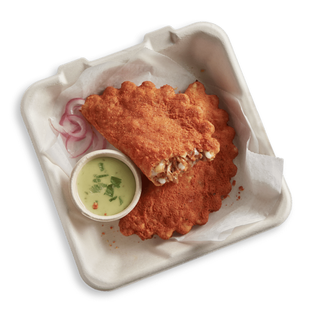 Two El Monterey Beef Birria Empanadas in a to-go container with salsa on the side
